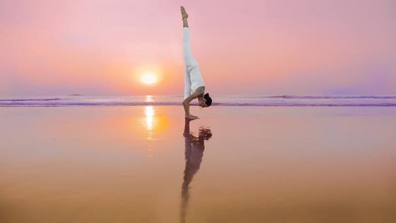 eka pada uttananasana, Standing Split, Urdhva Prasarita Eka Padasana, at the beach in goa, india, yoga teacher training in shreehari yoga school