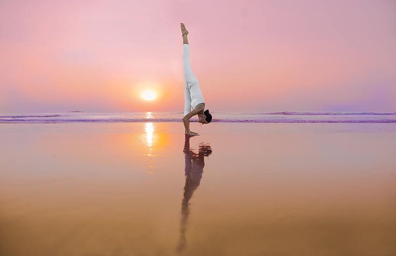 eka pada uttananasana, Standing Split, Urdhva Prasarita Eka Padasana, at the beach in goa, india, yoga teacher training in shreehari yoga school