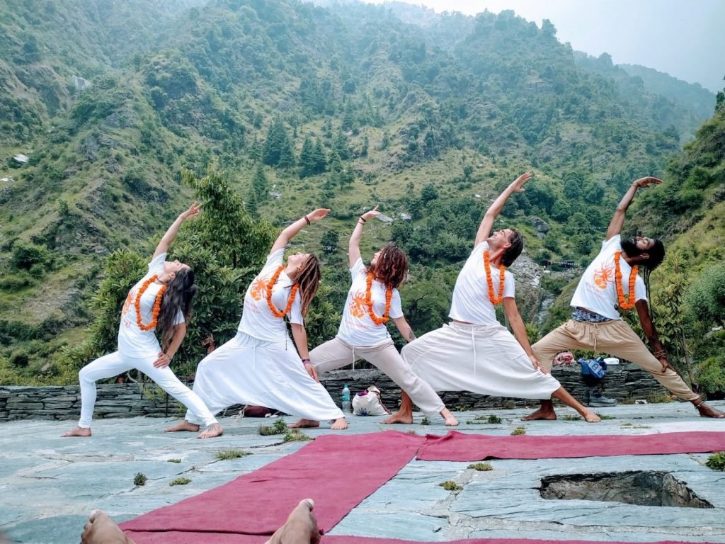 warrior posing in the himalayas from shree hari yoga students in rishikesh