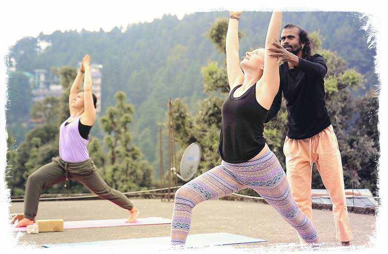 warrior1-hari-student | Yoga Teacher Training in India at Shree Hari School | Certified YTT course yoga teacher is aligning studend in warrior pose